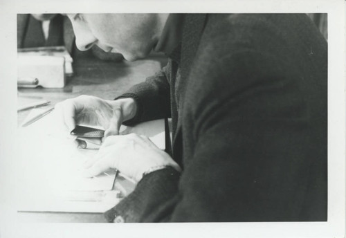 Hans-Martin Shenke studying manuscript