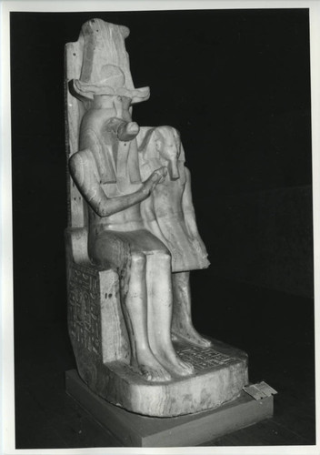 Statue of Egyptian god with hieroglyphs