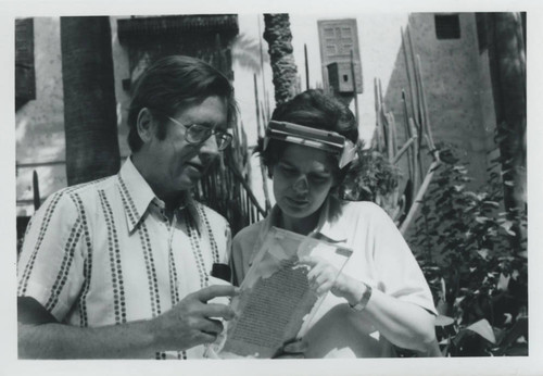 James Robinson and Anita Weisbrod Robinson examine a codex outside the Coptic Museum