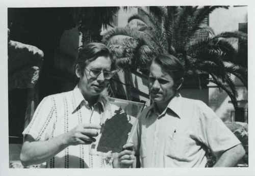 James Robinson and Charles Hedrick look at a codex outside the Coptic Museum