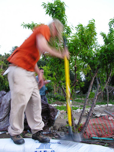 Student tamping earth dome wall