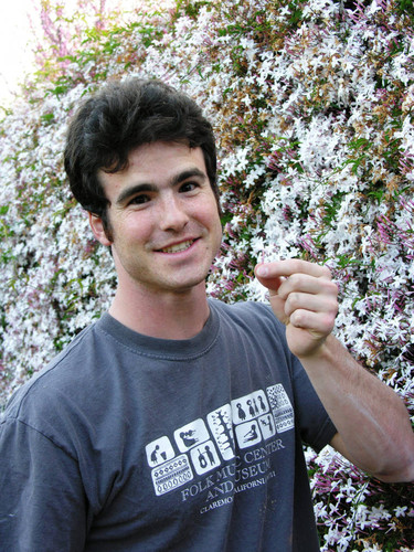 Smiling student holding flower