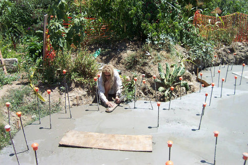 Student smoothing wet concrete