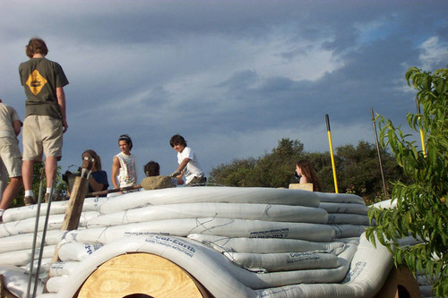 Students stand on Earth Dome beneath cloudy sky