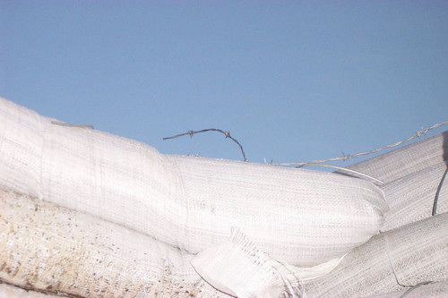 Barbed wire over earthbags