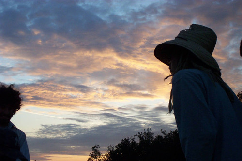 Silhouette of person wearing hat