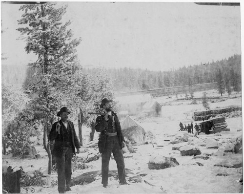 Two armed men at winter camp