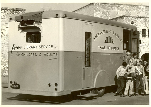 Boys pose at entrance to Sacramento City Library Traveling Branch