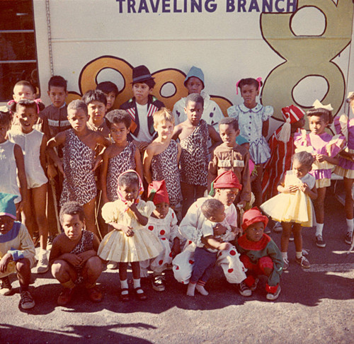 Costumed children in front of bookmobile