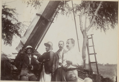 [Member of the solar eclipse expedition sitting in front of the Pierson telescope, Camp Pierson, Wangi, India]