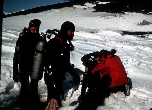 Divers headed for hole in sea ice. James Stewart in middle. McMurdo Station, Antarctica