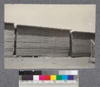 Lumber piled at mill on St. Croix River, at Baring, Maine. D.T. Mason 1919