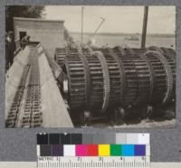 Barking wheels in process of installation - plant of St. Maurice Lumber Company, Three Rivers, Quebec. These wheels when completely installed receive pulpwood sticks from conveyor at left. The revolving wheels bark the wood