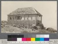 Lookout for watchman's cabin on Spanish Peak, Plumas National Forest, California. Guard Lew Chase, seated. July, 1920. E.F