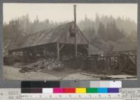 Mill of Payne & Davis Lumber Company 1/4 s. of Quincy, California. An old mill, operated in 1920 after 15 years of idleness. Note traction boiler at one end (replaces old water wheel). August, 1920. E.F. 5.211