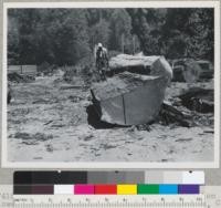 Redwood Region, Chris Gilson's operation on lower Turwar County. Klamath River, near Klamath, California. Titan chain saw used for ripping redwood logs. Single-saw sawmill in background. Nearing end of the cut. 8/17/48. E.F