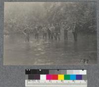 After an all day hike in the rain, the high school forestry class waded the river back and forth to get to camp at the Lime Kilns, Oct. 5, 1918