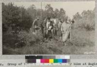 Group of teachers on a nature-study hike at Saginaw Forest near Ann Arbor, Michigan, observing pheasants' nests near the weather station. October 1932. Metcalf