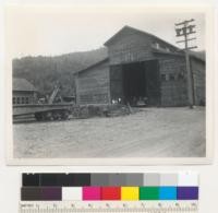 Redwood Region. Pacific Lumber Company, Yager Creek camp, Humboldt County, California. Machine shop. "Cat" (tractor) ramp in foreground. 5-22-42, E.F