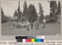 Burial procession for the two bad "Generals' at Whitaker's Forest moved across the play field from the flag pole to the gulley behind Lindsay and Galbraith who carried symbols of order. Metcalf. July, 1928