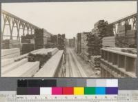 Lumber stored in Unit packages on piles between crane runway. Union Lumber Company, Fort Bragg, California. May, 1920. E. F