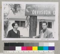 Fernando Gil and Jose Nicolas of Spanish Forest Service view sprouting redwood post at CDF Headquarters, St. Helena. Metcalf. May 1954