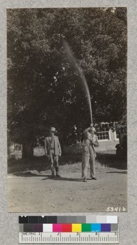 Forest Ranger Dean Mathews demonstrated the vertical throw of the Indian fire pump in heavy wind