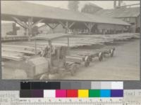 Sorting table. Showing Hood locomotive (Ford engine) for handling loaded lumber trucks about the yard. Holmes-Eureka Lumber Company, Eureka, California. May, 1920. E. F