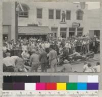 Camp Califorest. Tug-of-war contest on Main St. in Quincy, California. 4th of July celebration. Foresters to right. Lost contest. 7-4-39. E.F