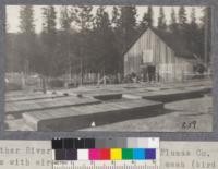 Feather River Experiment Station, Plumas County. The seed beds with wire sides and tops 1/2" mesh (bird and gopher proof), Lath covers and burlap. Barn in the background. Seed beds are 4' x 12'. Germination tests to check those made in the greenhouse are made here in these beds. The tests sometimes extend over two seasons. The first season the bed is gone over every day and the second season once a week. As there are 200 seeds in each test, every seed equals about 1/2 of 1%. The total % of germination is carried forward on the card each time the count is made