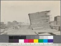 Lumber pile, showing method of piling somewhat common in Humboldt County. Pile slopes forward and rear end is higher than front end. Bayside Redwood Company. Eureka, California. May 25, 1920. E. F