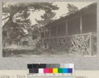 Tent house building at Asilomar, Pacific Grove, 90 ft. x 24ft. wide, having canvas partitions around rooms 10' x 10' to accommodate 2 persons. Each unit has wash room, showers and toilets in 2 center compartments and will accommodate 32 people