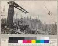 Showing a landing at the Freshwater operations of the Pacific Lumber Company, Humboldt County. One of the loading crew is just releasing the tongs from a log which has been placed on the car from the loading boom. At the right of the picture is shown a portion of the yarding rigging just as the log was brought in. E.F. June 1931