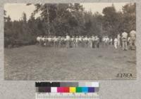 The Tehama 4-H Club members lined up into tribal groups at Mineral, Lassen National Forest, 1930. [Handwritten addendum to caption reads:" Frank Spurrier center".]