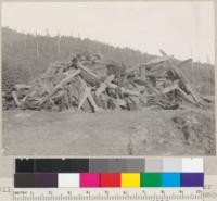 A pile of stump wood. Pacific Lumber Company field south of its Scotia yard. Stumps were burned off at base by a semi-charcoaling process. January, 1936. E. F