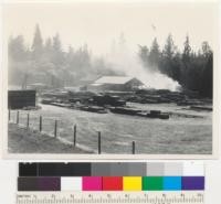 Redwood Region. Philo Lumber Company, Philo, California on Navarro River road. (Perkins & Salsig). Circular head saw. About 25 M per day. Smoke is from slab fire. 11-1942. E. F