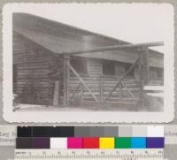 Log barn and double gate made of California red fir poles. Bercutt-Richards Company, Sacramento