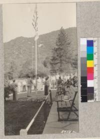 Raising the flag at White Oak Flat 4-H Club Camp. Ventura, Santa Barbara and San Luis Obispo. W. Metcalf. June 1931