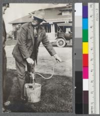 Forest Supervisor Durbin of the Modoc shows how to put out stump fires with a Myers bucketpump