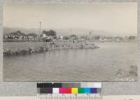 Some of the crowd at the opening of Kern River Park, Kern County, with the artificial lake and island and bath houses near the hot spring in rear. May, 1929. Metcalf