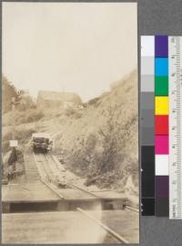 The yards of this company are on a plateau above the mill level. Photo shows cable incline pulling lumber from end of sorting table up to yards. Caspar Lumber Company, Caspar, California. May, 1920. E. F