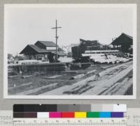 Douglas fir region. Back end of Mahoney and Chambers mill, Albany, Oregon. See also 7333-5. Planner to right. Product sold rough green. Produces 18 M - 23 M per 8 hours. All second growth. One of the first mills in Albany. Circular head rig. Sept. 10, 1945. E. F