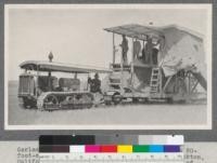 Gerlach Brothers' Best "40" Tracklayer pulling a 20-foot-cut Harris auxiliary harvester, near Stockton, California. This machine is cutting 40 acres of grain a day. C. L. Best Gas Traction Company, San Leandro, California. Old type spark arrester superseded 1918