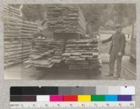 Lumber sawn from 50-55 year old second growth Douglas fir, white fir, spruce, redwood. Felled at Freshwater, Humboldt County, and sawn in mill at Scotia. Nurseryman in picture