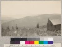 Montezuma Mine building on Spanish Peak. Mine financed by Doctor Pierce of "Golden Medical Discovery" fame. Abandoned about 15 years previous. View is toward mouth of Bear Creek, Camp Califorest views. 1923