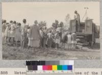 Metcalf demonstrating the use of the Indian fire pump at the Fallbrook meeting, San Diego County. Fairbank putting away fire extinguishers. Metcalf. May, 1929