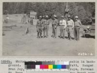 Whitaker's Forest with Madera cabin in the background. Left to right: State Forester Pratt, Ranger Evan Joy, Ranger Gossett, Deputy Coupe, Foreman William Haas, and Superintendent Lovelace of Maxon Ranch camp. 1935. Metcalf