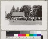 Flag raising at Whitaker's Forest headquarters during the Tulare-Fresno 4-H camp, July 1942. Metcalf