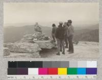Schumacher, Fritz, J. Price, and D. C. Birch looking into Chiquita basin from summit of Fresno Dome, Sierra National Forest, May, 1925