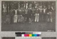 The group of boys near Camino, El Dorado County, which organized a forestry 4-H club, April 1933, with their leader, Bill Cummings. Their plot of second-growth trees is in the background. Metcalf